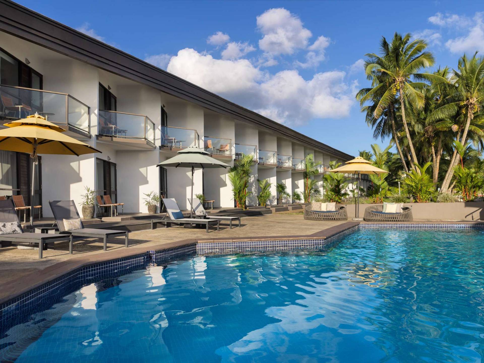 Novotel Suva Lami Bay poolside rooms with palm trees