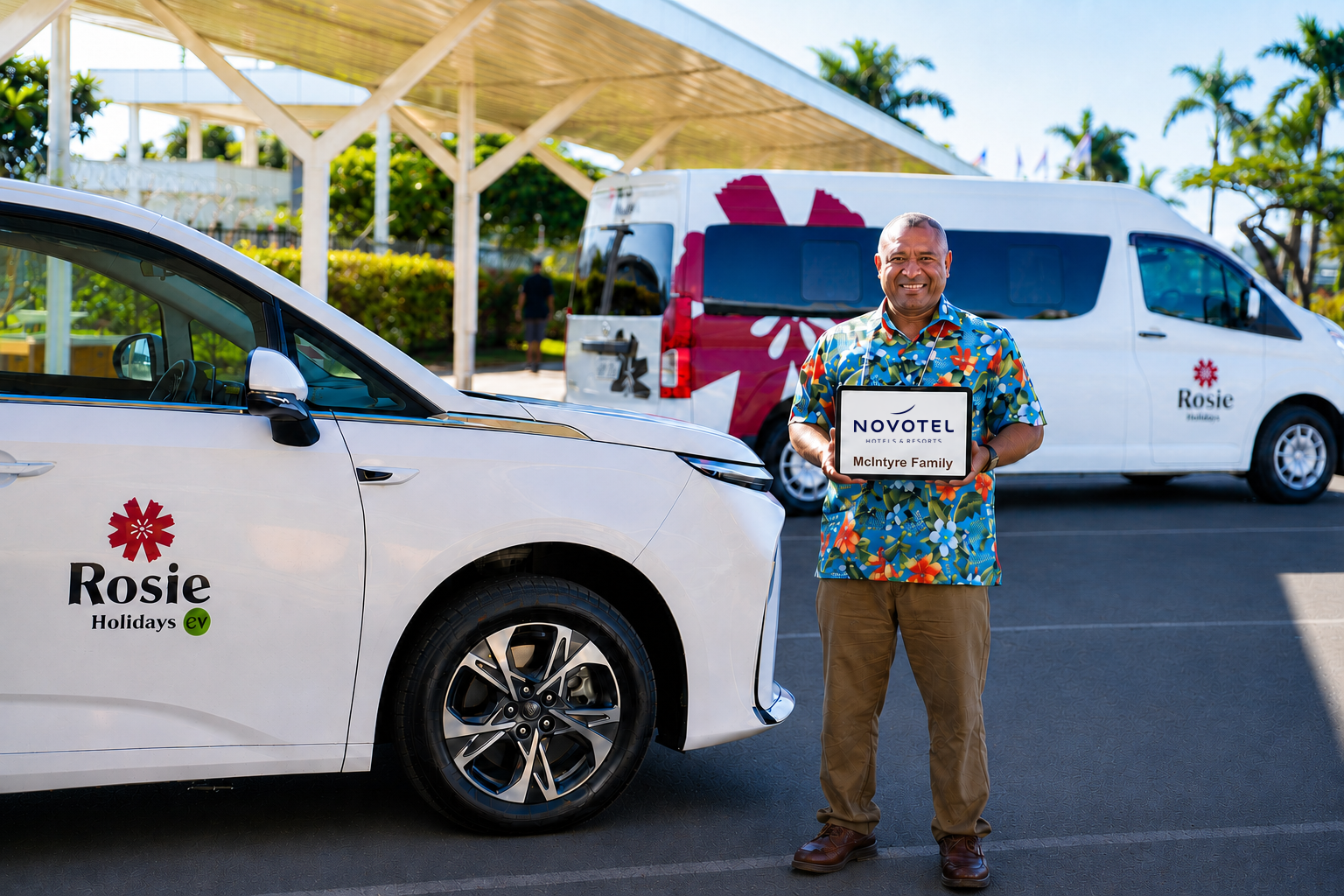 Rosie Holidays driver holding Novotel Suva Lami Bay meet & greet sign beside EV and fleet van
